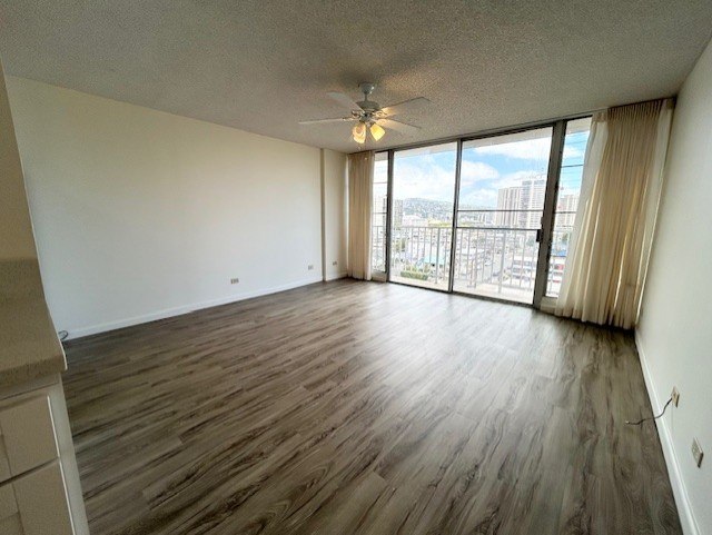 A room with wooden flooring and a ceiling fan.